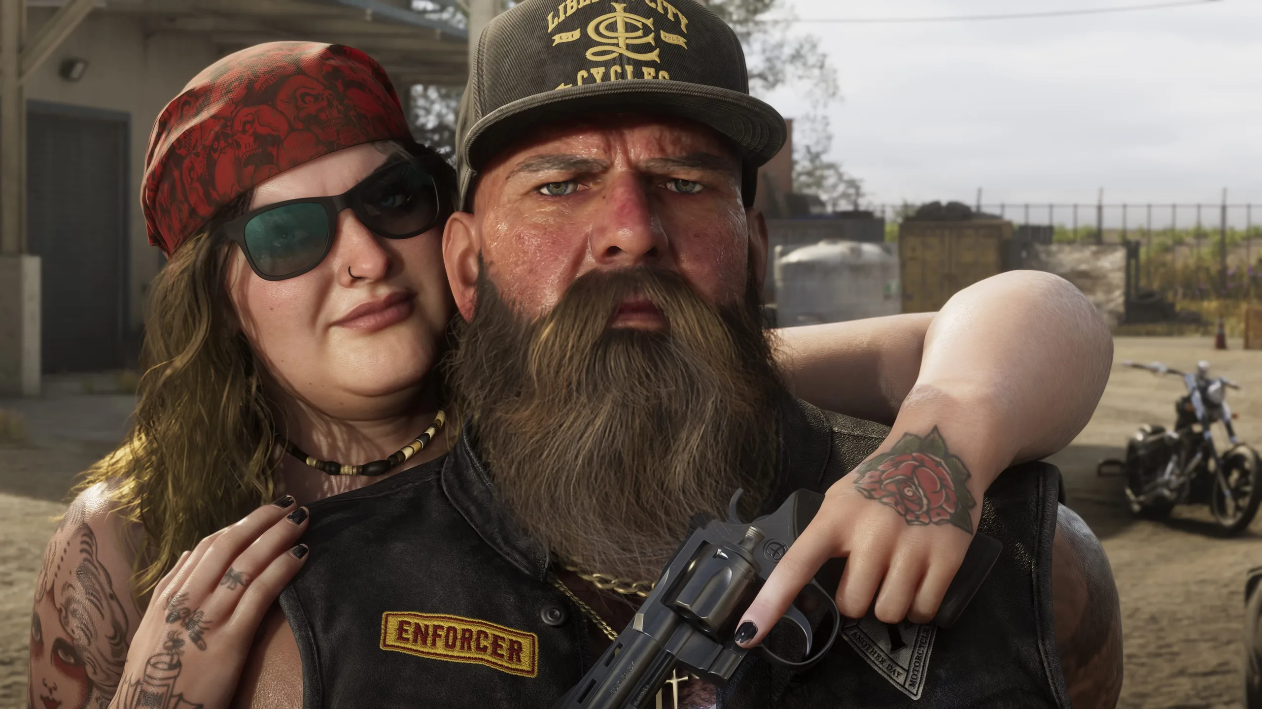 A biker couple pose outside a club