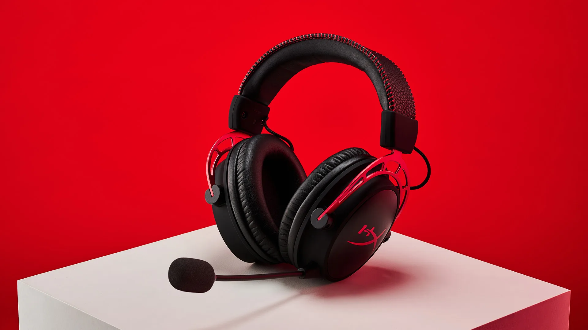 HyperX Cloud Alpha Wireless headphones on a red background