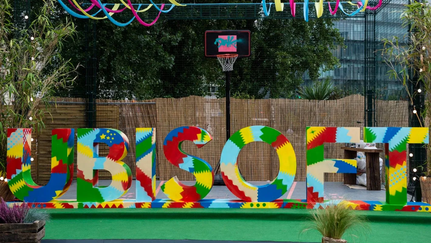 Colorful Ubisoft sign with basketball hoop.