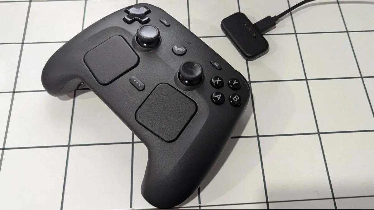 Steam Controller with charging dongle.