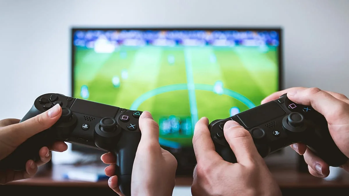 Two people playing a multiplayer game on PlayStation.