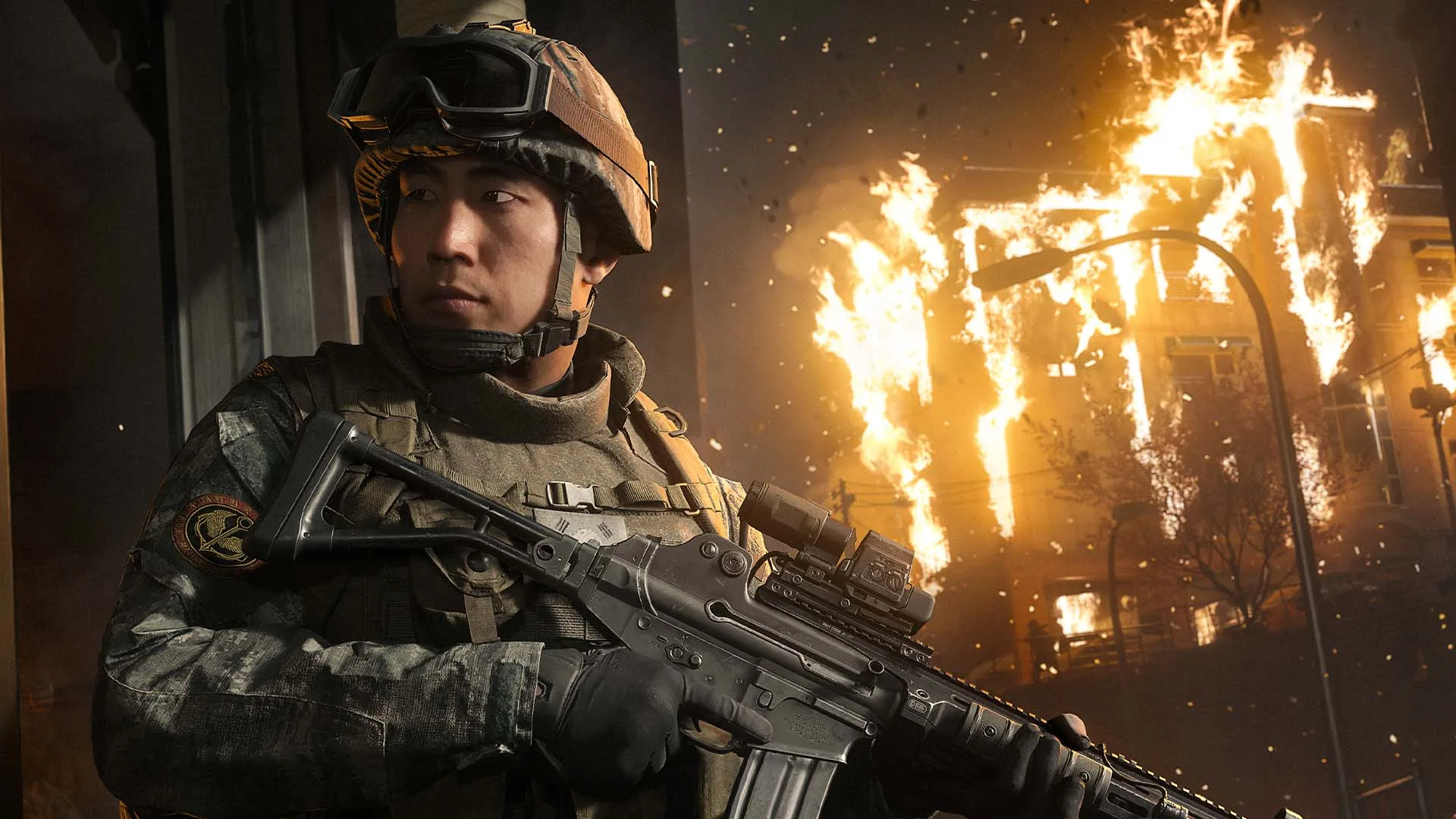 Soldier in combat with explosions in the background.