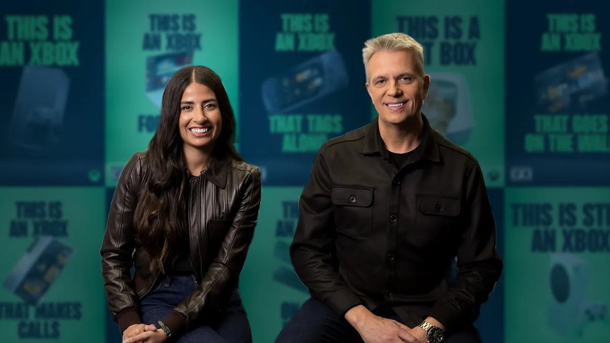 Asha Sharma & Matt Booty of Xbox, with 'This is an Xbox' promo material in the background.